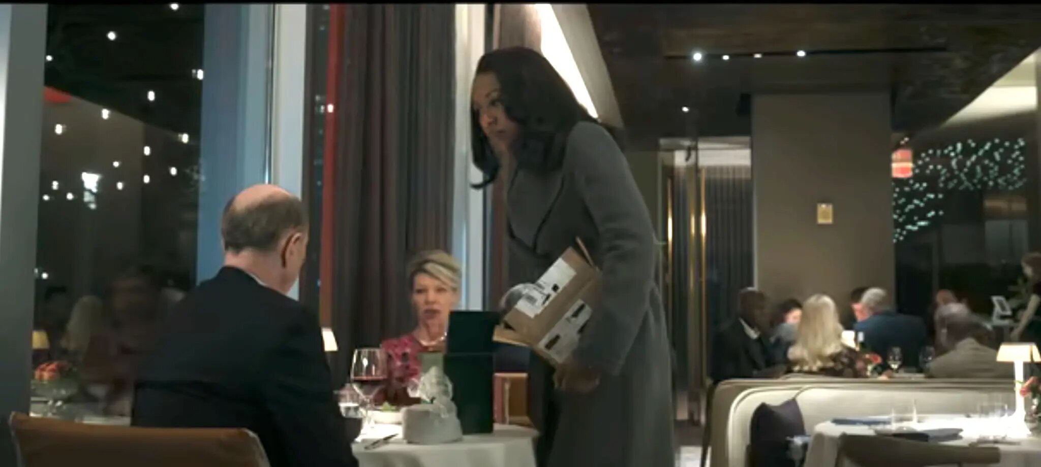 Gini rises from the restaurant table opposite Byron Gedney