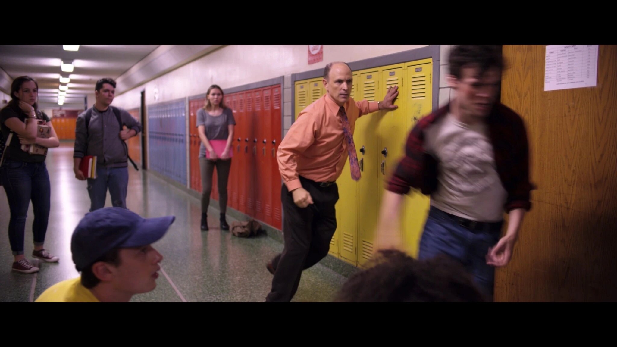 Mr. Deere turns as a student runs past him in the hallway